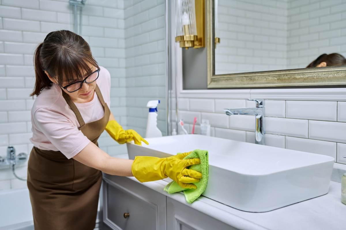 Why Does My Bathroom Sink Smell Like Rotten Eggs? How to Fix 3 woman cleaning bathroom